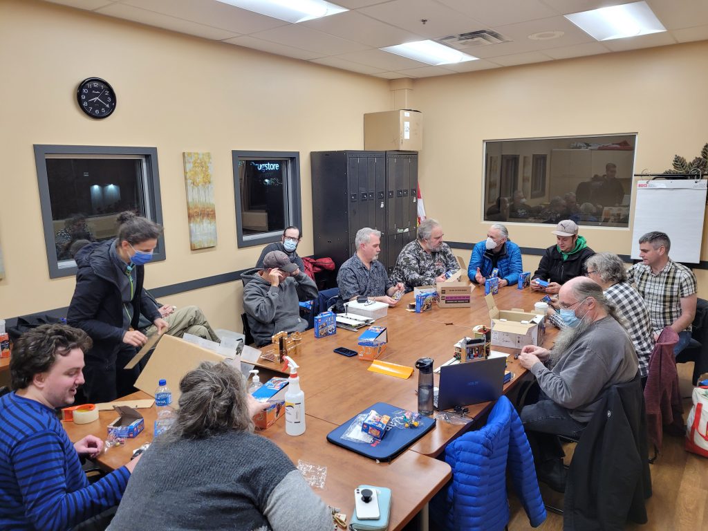 MILUG members sitting around a board room table at a meeting.