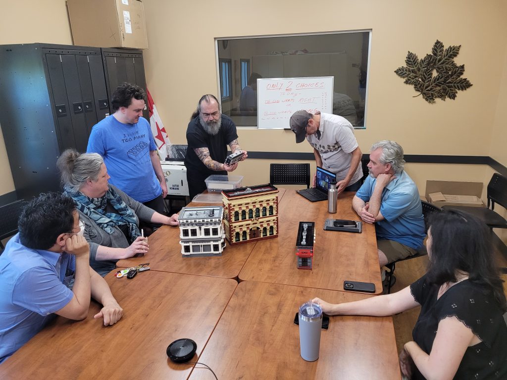 MILUG members around a table looking at custom LEGO models